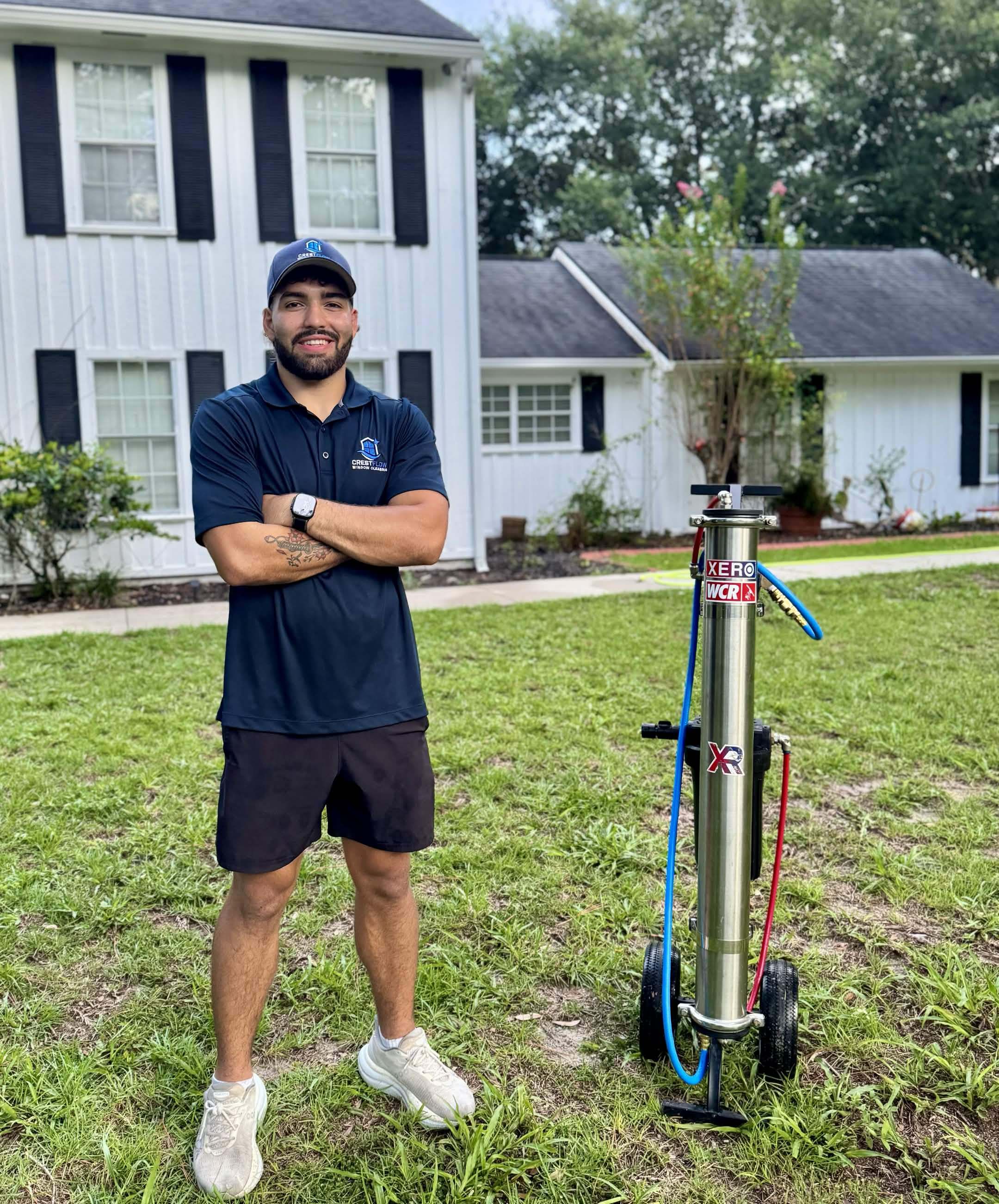 CrestFlow technician standing beside a Xero WCR deionized water filtration cart on a residential lawn